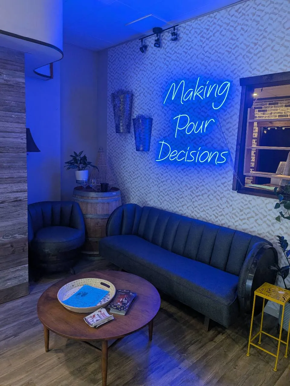 The lounge seating area inside Kog Hill Winery at 310 Vine Cellar, with the Making Pour Decisions sign